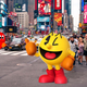 A big, human-sized Pac-Man gives a thumbs up in the middle of New York City.